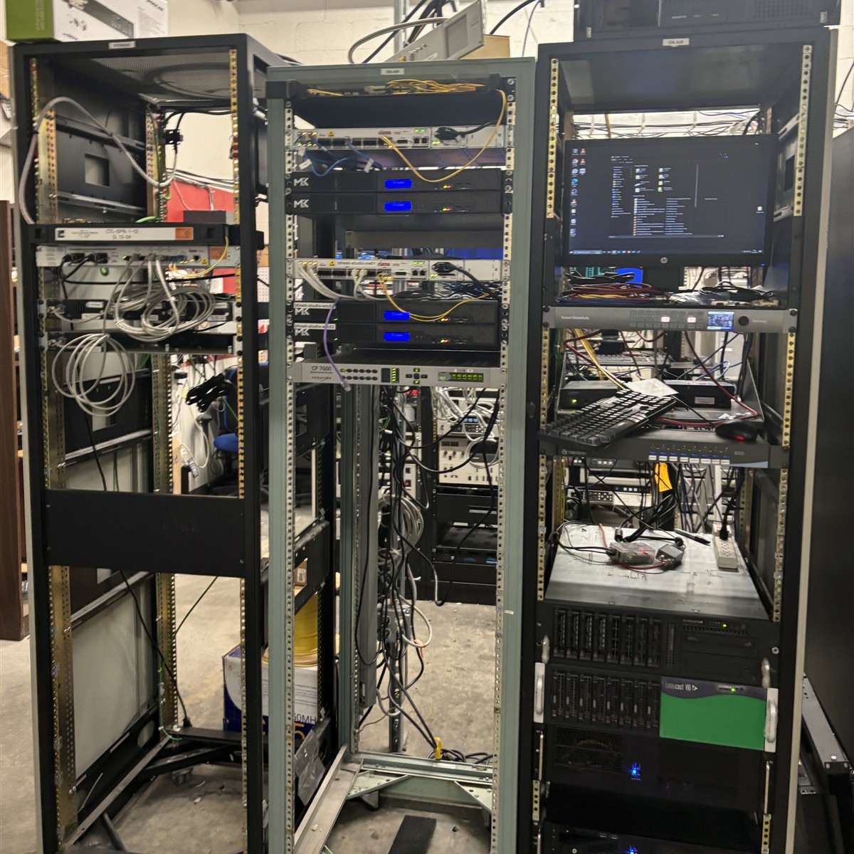 A real SPNN server rack with storage equipment and cables; square crop of a photograph by Myotus